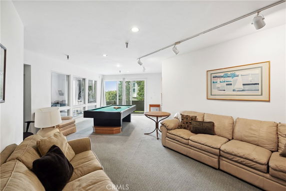 Room with sofas and a billiards table.