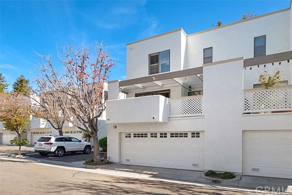 Front view of a modern multi-story house with a double garage.