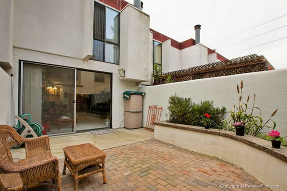 Outdoor view of building from patio with sliding glass door.