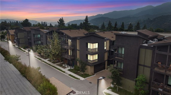Front view of multi-story residential buildings at sunset.