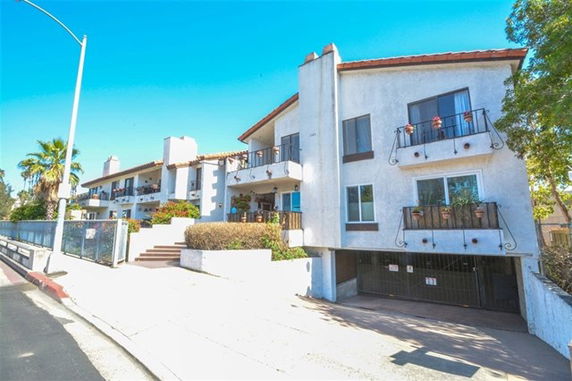 Front view of a multi-story residential building with balconies