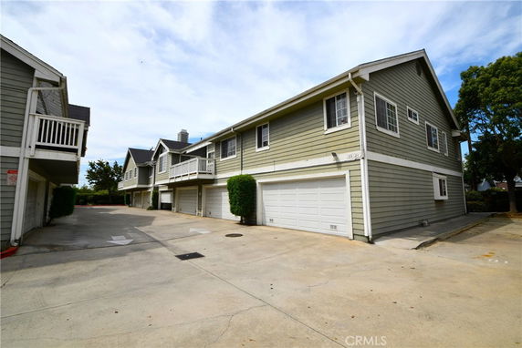 Front view of a multi-unit residential building with garages.