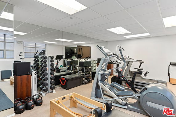 Indoor gym area with exercise equipment and mirrors.