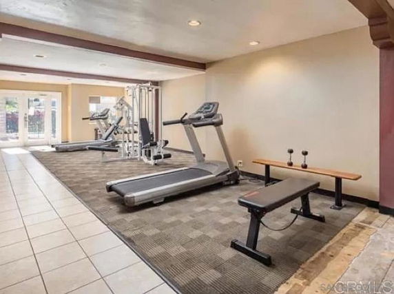 Indoor gym area with fitness equipment including treadmills and weight bench.
