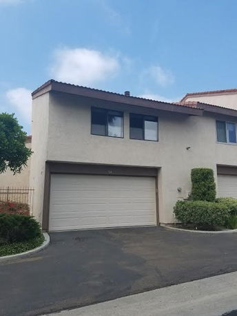 Front view of a two-story house with a double garage.