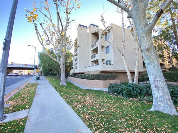 Side view of a multi-story residential building with balconies.