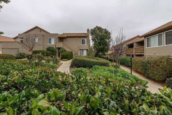 View of residential buildings with pathways and greenery.