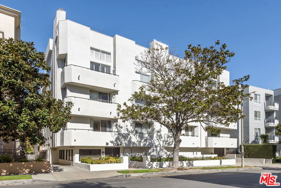 Front view of a modern multi-story building with balconies.