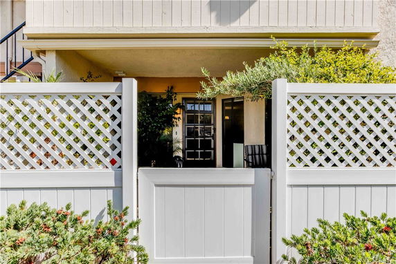 Front view of a house with a lattice fence and gate