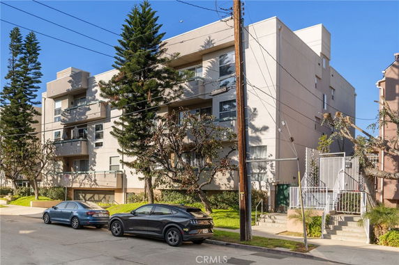 Front view of a multi-story apartment building with balconies.