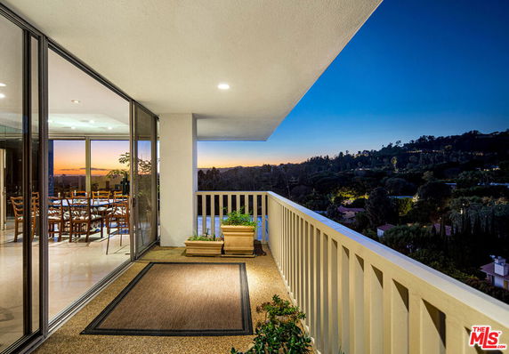 Balcony with a view of the surrounding landscape at sunset.