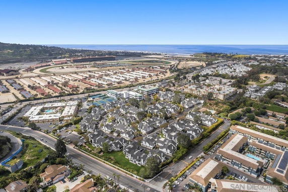 Aerial panoramic view of a residential area with nearby facilities and open spaces.
