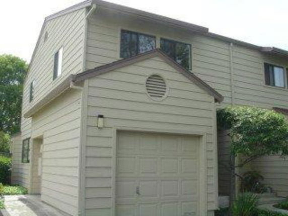 Front view of a two-story house with an attached garage.