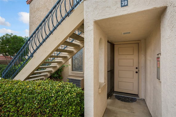 Front view of a building entrance with an external staircase.