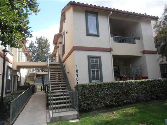 Front view of a two-story building with staircases and balconies.