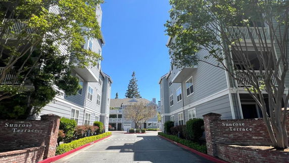 Front view of a multi-story apartment complex named Sunrose Terrace.