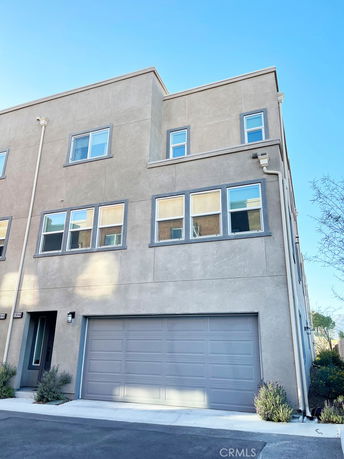 Front view of a multi-story townhouse with a two-car garage.