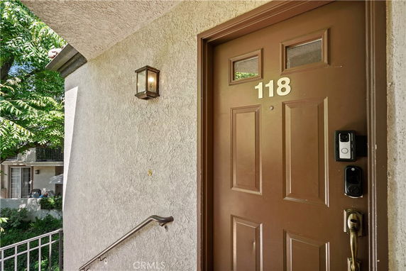 Entrance door of a residential building with number 118.