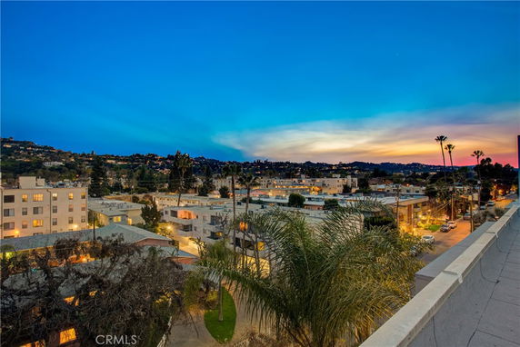 Panoramic view of a residential area seen from a rooftop at dusk.