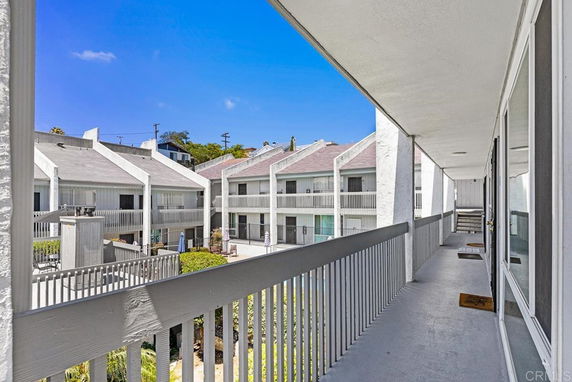 View of a multi-story apartment building with balconies.