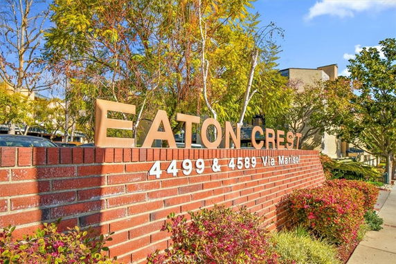 Front view of a building with a brick sign stating 'Eaton Crest' and building numbers.