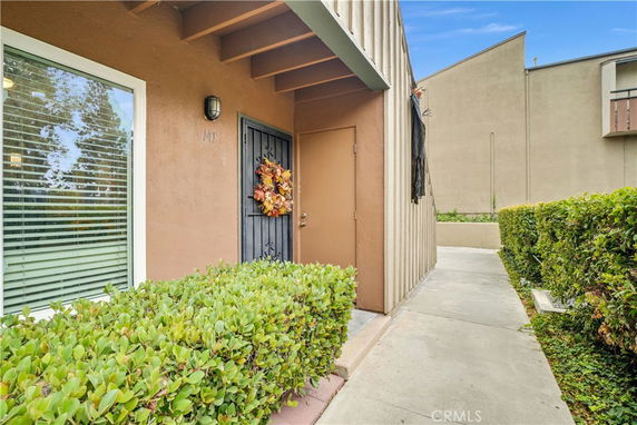 Front view of a house entrance with a decorated door.