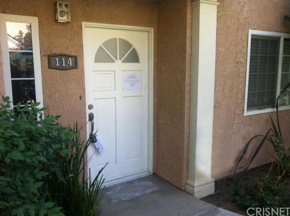 Front view of a house entrance with a white door and window.