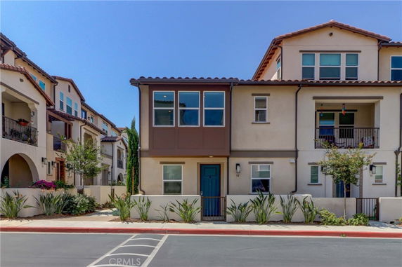 Front view of a multi-story townhouse with a modern exterior design.
