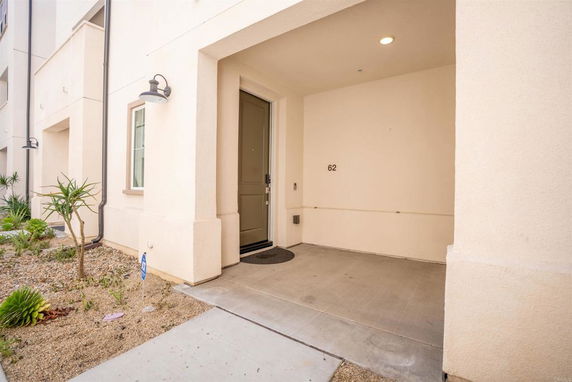 Front view of a building entrance with a covered porch and door.