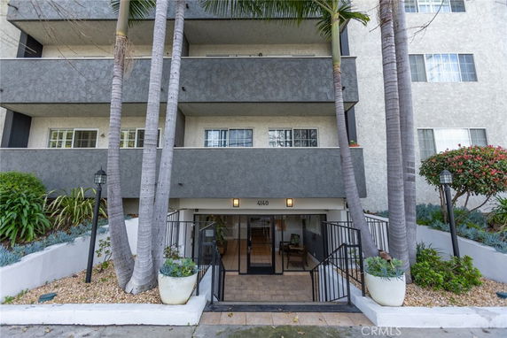 Front view of a multi-story residential building with balconies.