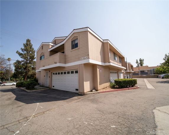 Front view of a two-story building with garages on the ground floor.