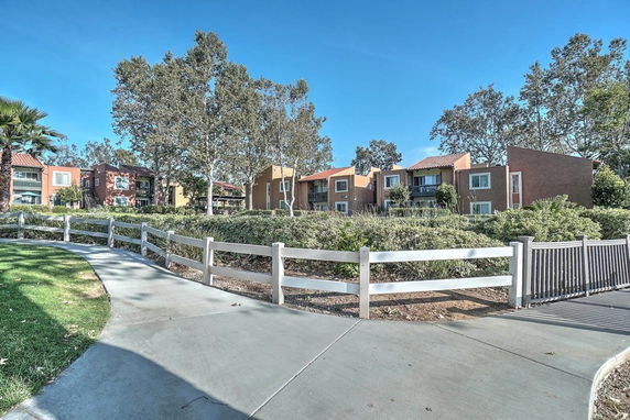 Front view of apartment buildings with multiple units and balconies.