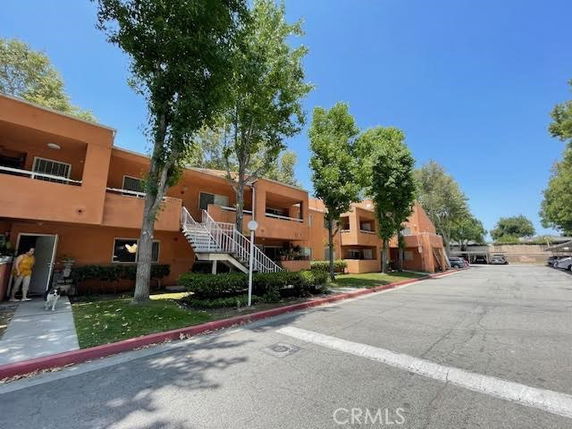 Front view of a two-story apartment building with exterior staircases.