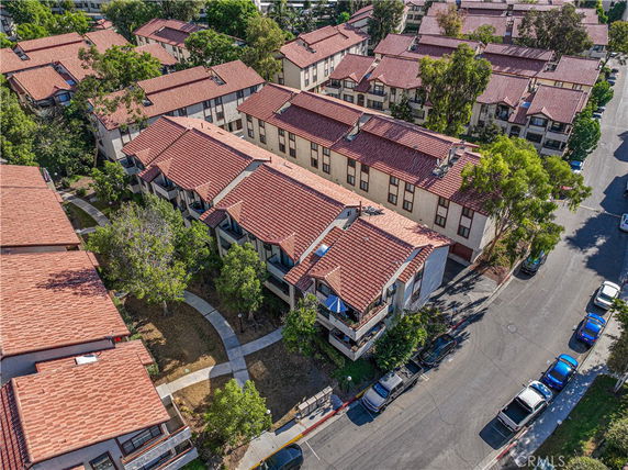 Aerial view of residential buildings with red-tiled rooftops.