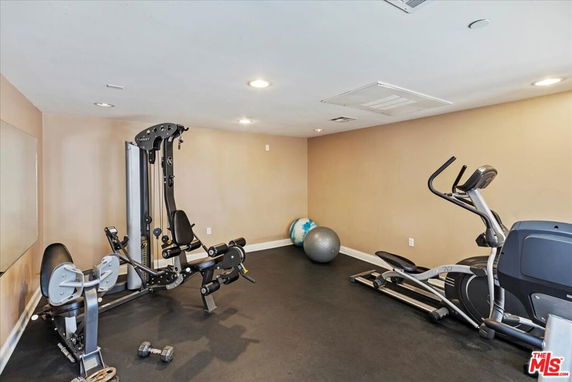 Indoor gym area with exercise equipment including a multi-gym and elliptical machine.