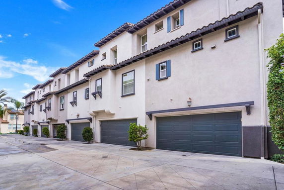 Front view of a multi-story building with garage doors.