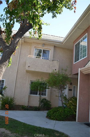 Exterior view of a two-story house with a small balcony.