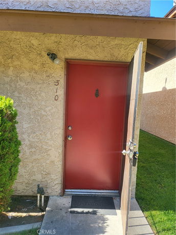 Front view of a house entrance with a red door.