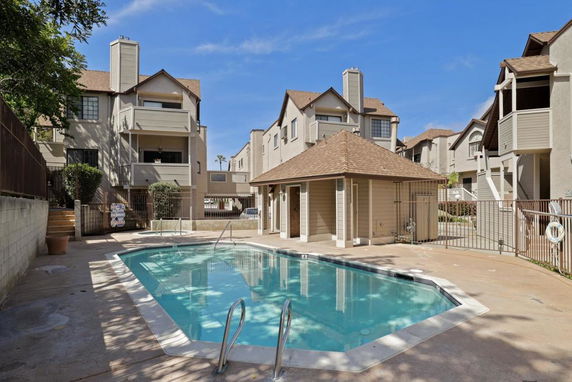 Outdoor swimming pool with surrounding buildings.