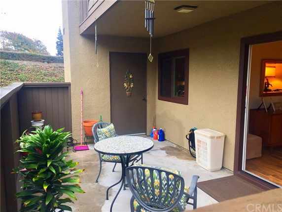 Patio area with outdoor furniture and a doorway leading inside.