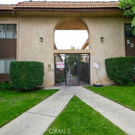 Front view of a building with a gated entrance and archway.