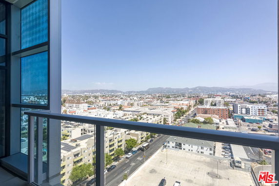 Wide angle view of urban surroundings from a high-rise building balcony.