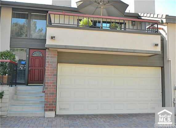 Front view of a house with a two-car garage and an entrance with steps.