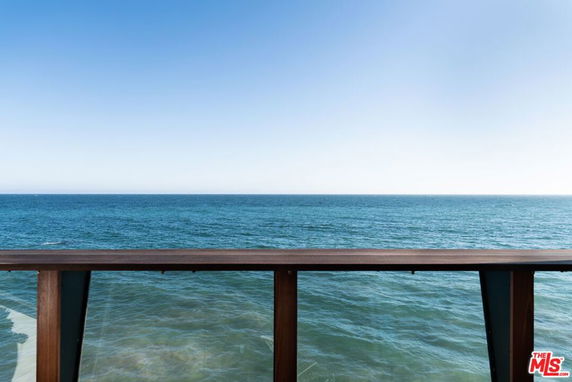 Panoramic view of the ocean from a balcony.