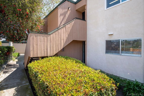 Front view of a two-story building with an exterior staircase.