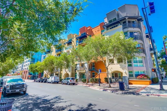 Front view of a multi-story building with colorful exterior and balconies.