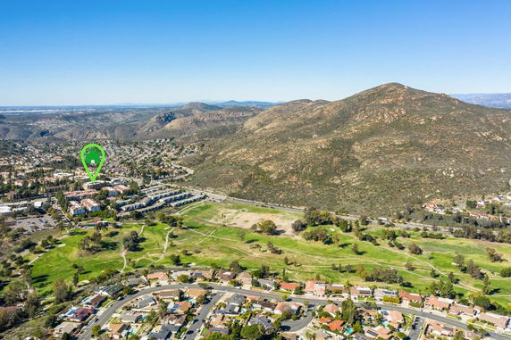 Panoramic view of a residential area with surrounding hills and landscape.