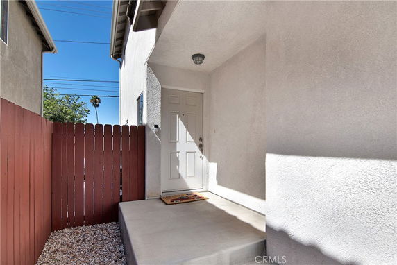Front view of a house entrance with a white door and small porch.