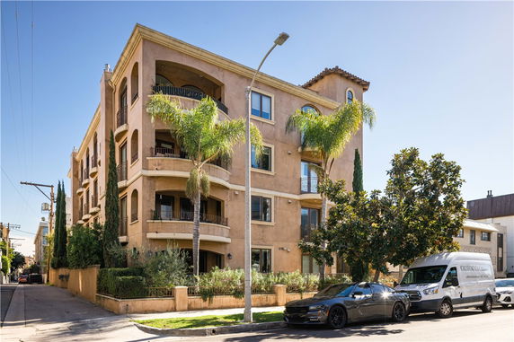 Front view of a multi-story residential building with balconies.