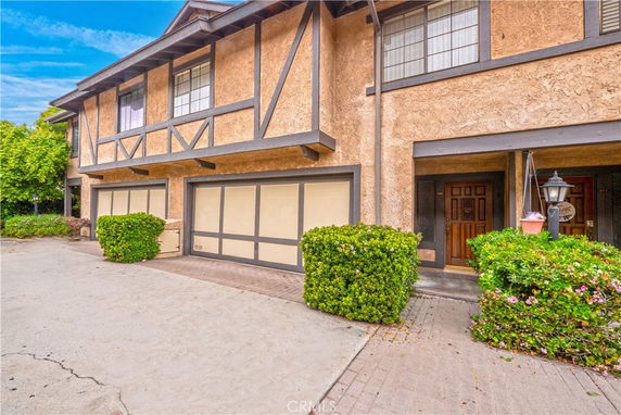 Front view of a two-story townhouse with a double garage.